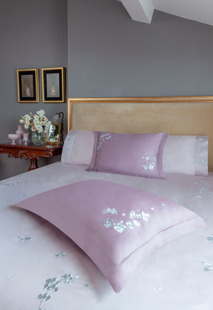 Butterfly Blossom Duvet Cover Set in pink Egyptian cotton with butterfly embroidery – flanged shams and pillowcases on bed, styled in luxury bedroom.