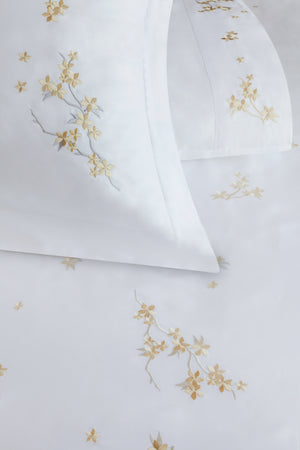 Detail of Cherry Blossom Duvet Cover Set – flowers embroidered on Egyptian cotton pillow shams and top sheet.
