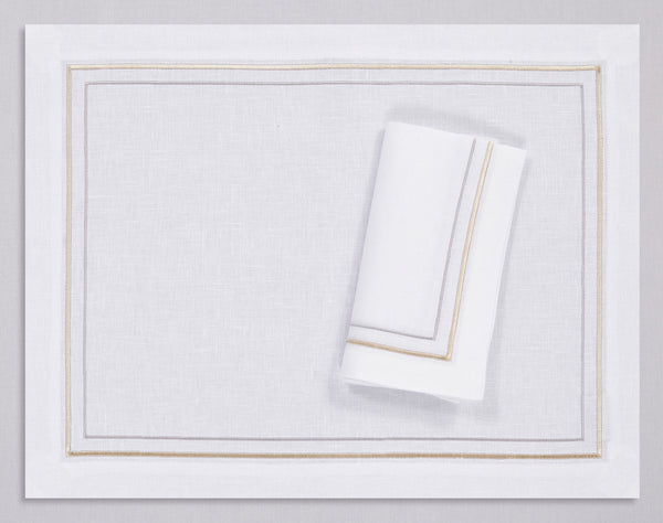 White linen placemat and napkin set embroidered with gold and silver line motif border, 100% European linen, handcrafted by Plein Soleil.