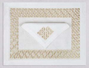 White linen placemat and napkin set embroidered with gold damasque motif border, 100% European linen, handcrafted by Plein Soleil.