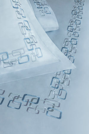 Detail of Geometric Duvet Cover Set – geometric embroidered border on Egyptian cotton pillow shams and top sheet.