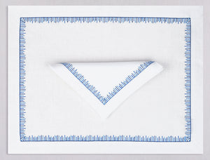 White linen placemat and napkin set embroidered with blue mikado motif border, 100% European linen, handcrafted by Plein Soleil.