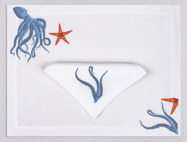 White linen placemat and napkin set embroidered with a blue octopus and orange starfish, 100% European linen, handcrafted by Plein Soleil.