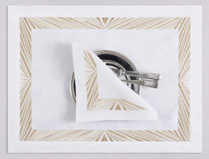 White linen placemat and napkin set embroidered with gold Paris motif border, 100% European linen, handcrafted by Plein Soleil.