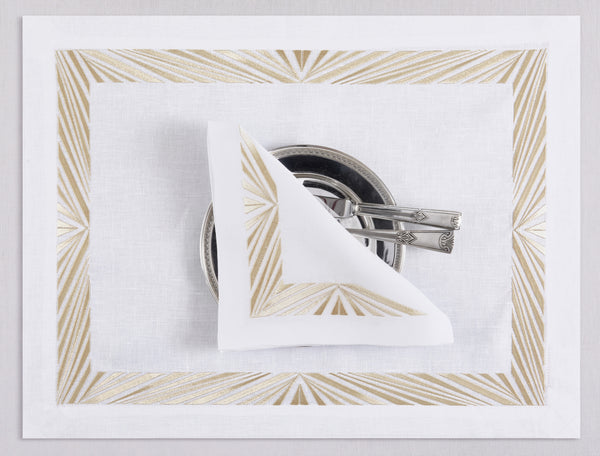 White linen placemat and napkin set embroidered with gold Paris motif border, 100% European linen, handcrafted by Plein Soleil.