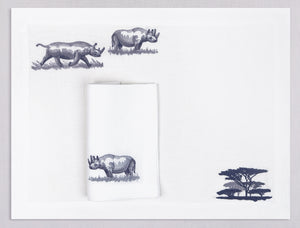 White linen placemat and napkin set embroidered with rhinos and safari trees, 100% European linen, handcrafted by Plein Soleil.