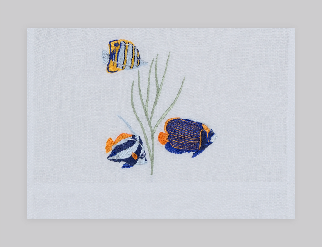 Set of white linen guest towels embroidered with purple, yellow, and pink thistle flowers – luxury floral bath linens by Plein Soleil.