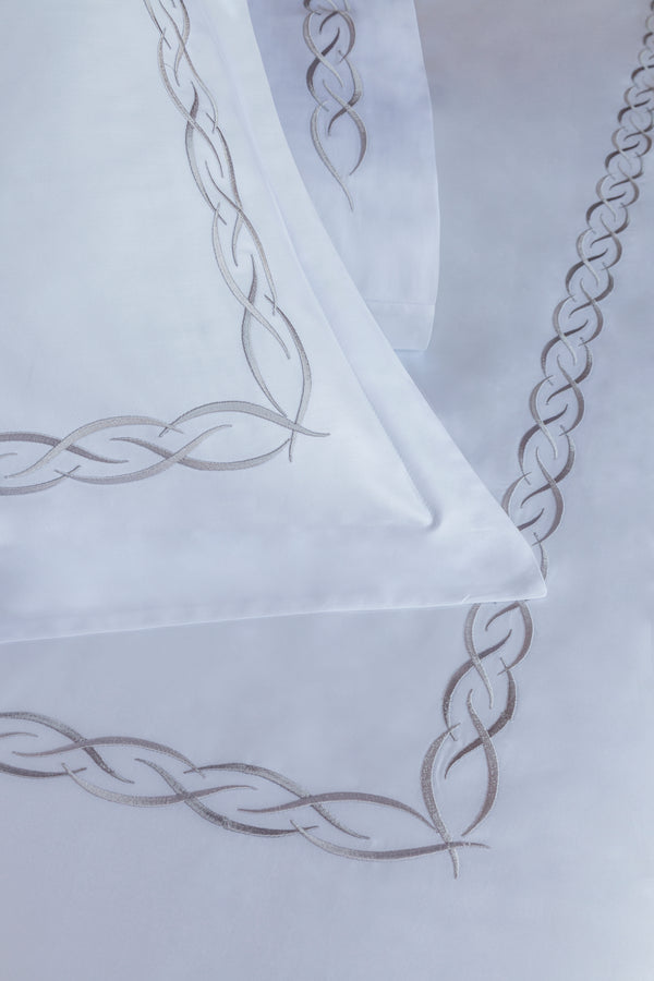 Detail of Ava Duvet Cover Set – elegant linked loop embroidered border on Egyptian cotton pillow shams and top sheet.