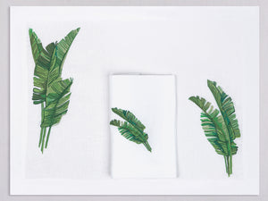 White linen placemat and napkin set embroidered with green banana leaves, 100% European linen, handcrafted by Plein Soleil.