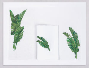 White linen placemat and napkin set embroidered with green banana leaves, 100% European linen, handcrafted by Plein Soleil.