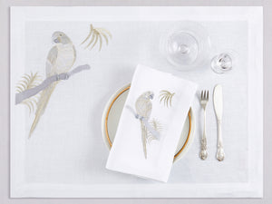 White linen placemat and napkin set embroidered with gold and silver macau bird, 100% European linen, handcrafted by Plein Soleil.
