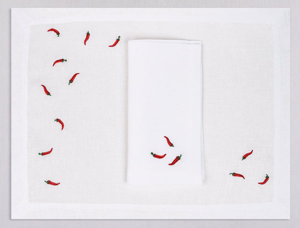 White linen placemat and napkin set embroidered with red cayenne peppers, 100% European linen, handcrafted by Plein Soleil.