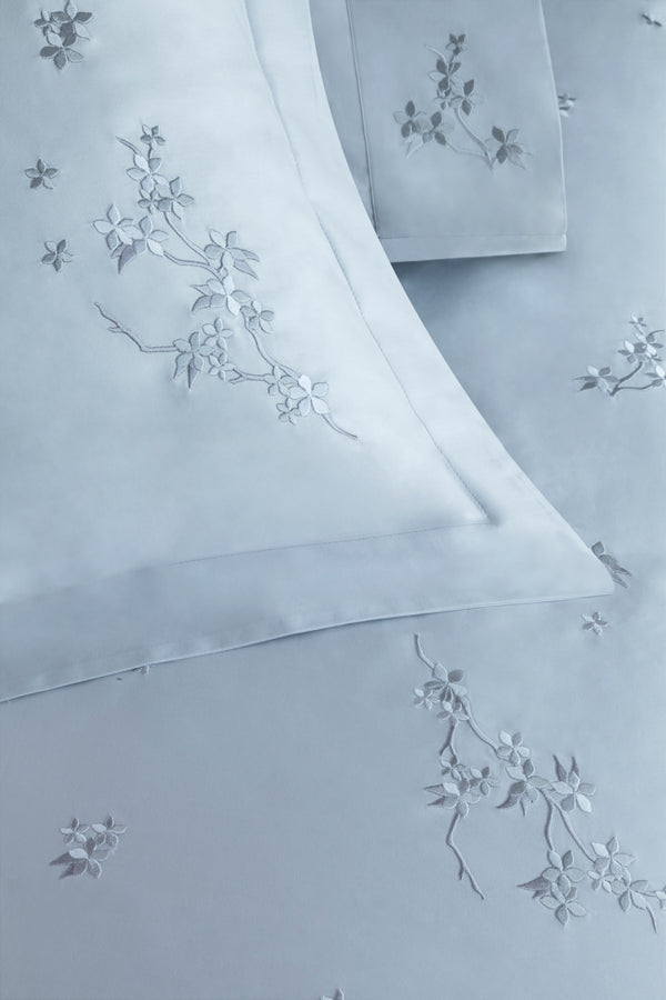 Detail of Cherry Blossom Duvet Cover Set – flowers embroidered on Egyptian cotton pillow shams and top sheet.