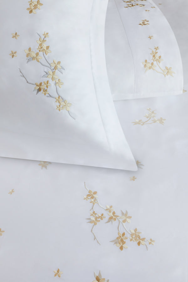 Detail of Cherry Blossom Duvet Cover Set – flowers embroidered on Egyptian cotton pillow shams and top sheet.