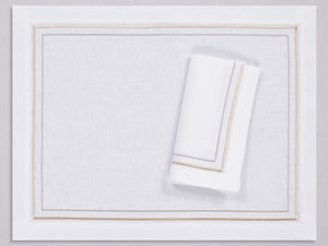 White linen placemat and napkin set embroidered with gold and silver line motif border, 100% European linen, handcrafted by Plein Soleil.