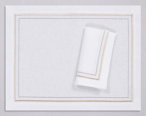 White linen placemat and napkin set embroidered with gold and silver line motif border, 100% European linen, handcrafted by Plein Soleil.