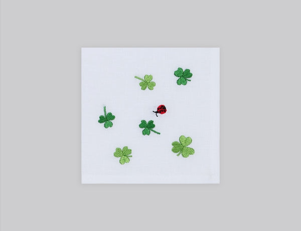 White linen cocktail napkin set embroidered with green cloves, 100% European linen, handcrafted by Plein Soleil.