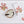 White linen placemat and napkin set embroidered with red coral and ivory shell, 100% European linen, handcrafted by Plein Soleil.