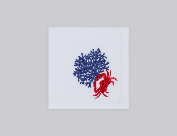 White cocktail napkin set embroidered with a navy coral and red crab, 100% European linen, handcrafted by Plein Soleil.
