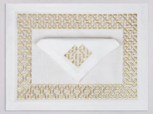 White linen placemat and napkin set embroidered with gold damasque motif border, 100% European linen, handcrafted by Plein Soleil.