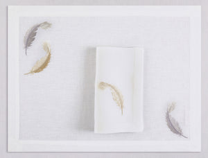 White linen placemat and napkin set embroidered with gold and silver feathers, 100% European linen, handcrafted by Plein Soleil.
