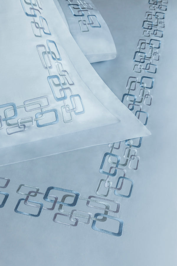 Detail of Geometric Duvet Cover Set – geometric embroidered border on Egyptian cotton pillow shams and top sheet.