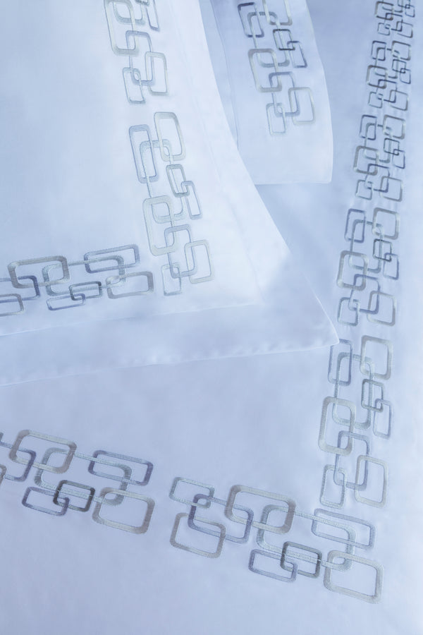Detail of Geometric Duvet Cover Set – geometric embroidered border on Egyptian cotton pillow shams and top sheet.