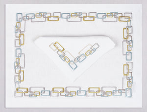 White linen placemat and napkin set embroidered with ice blue, gray, and gold geometric motif border, 100% European linen, handcrafted by Plein Soleil.