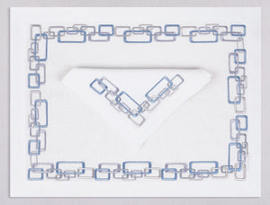 White linen placemat and napkin set embroidered with ice blue geometric motif border, 100% European linen, handcrafted by Plein Soleil.