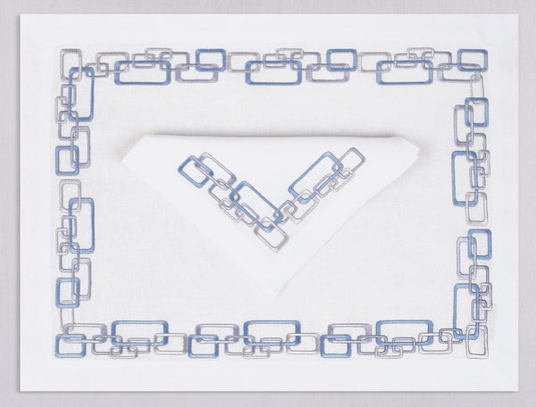 White linen placemat and napkin set embroidered with ice blue geometric motif border, 100% European linen, handcrafted by Plein Soleil.