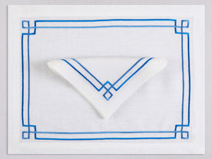 White linen placemat and napkin set embroidered with blue greek key motif border, 100% European linen, handcrafted by Plein Soleil.
