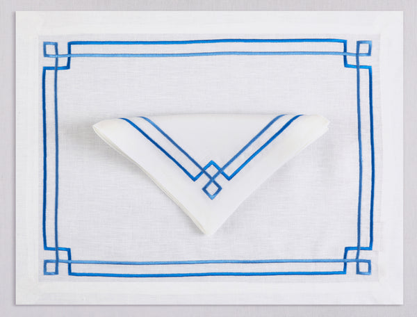 White linen placemat and napkin set embroidered with blue greek key motif border, 100% European linen, handcrafted by Plein Soleil.