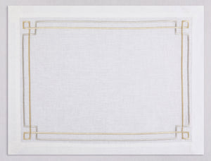 White linen placemat and napkin set embroidered with gold and silver greek key motif border, 100% European linen, handcrafted by Plein Soleil.