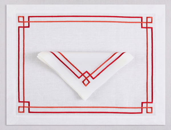 White linen placemat and napkin set embroidered with red greek key motif border, 100% European linen, handcrafted by Plein Soleil.