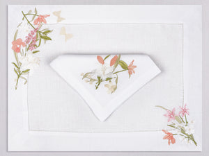 White linen placemat and napkin set embroidered with white, pink, and peach colored flowers, 100% European linen, handcrafted by Plein Soleil.