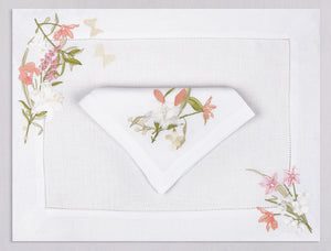 White linen placemat and napkin set embroidered with white, pink, and peach colored flowers, 100% European linen, handcrafted by Plein Soleil.