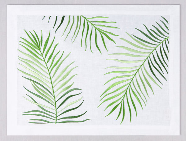 White linen placemat and napkin set embroidered with green le sud leaves, 100% European linen, handcrafted by Plein Soleil.