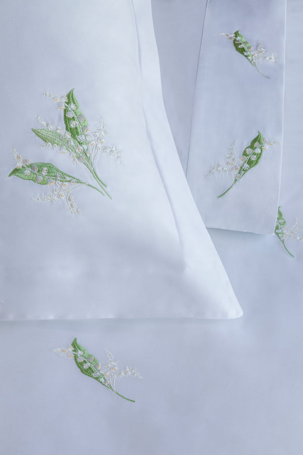 Detail of Lily of the Valley Duvet Cover Set – lily embroidered on Egyptian cotton pillow shams and top sheet.