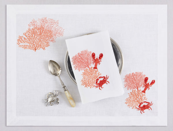 White linen placemat and napkin set embroidered with salmon colored corals and red lobster and crab, 100% European linen, handcrafted by Plein Soleil.