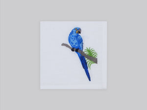 White linen cocktail napkin set embroidered with blue macau bird, 100% European linen, handcrafted by Plein Soleil.