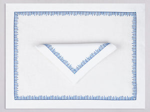 White linen placemat and napkin set embroidered with blue mikado motif border, 100% European linen, handcrafted by Plein Soleil.