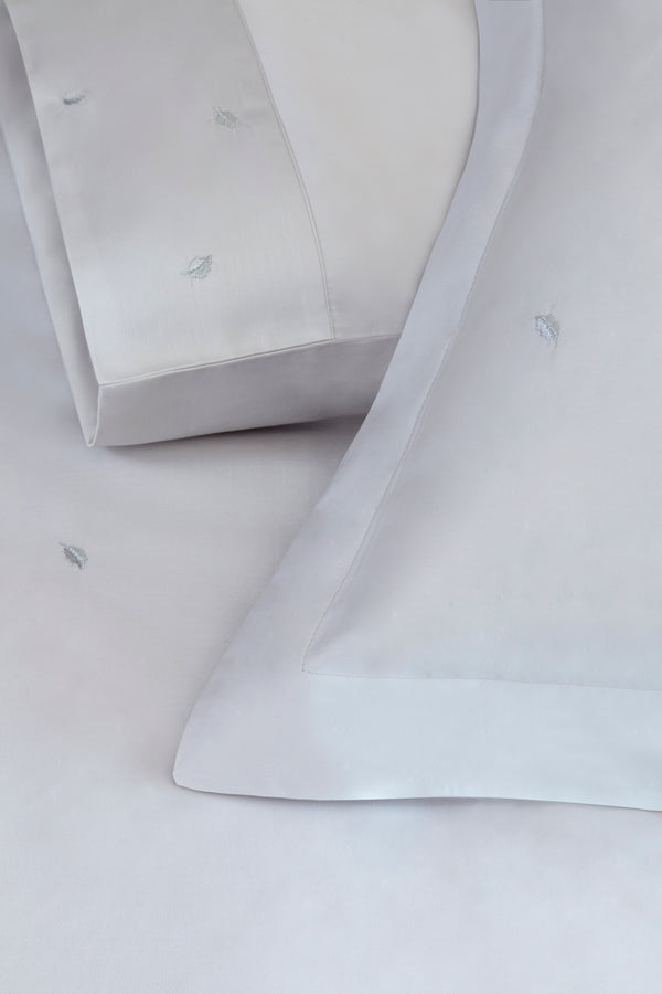 Detail of Mini Leaves Duvet Cover Set – small leaves embroidered on Egyptian cotton pillow shams and top sheet.