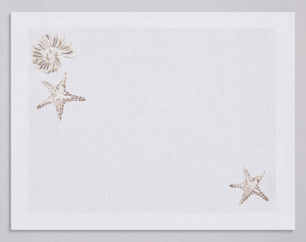 White linen placemat and napkin set embroidered with ivory starfish and nautilus, 100% European linen, handcrafted by Plein Soleil.