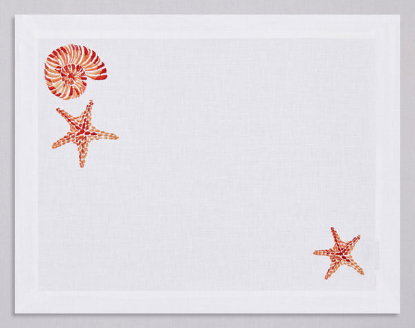 White linen placemat and napkin set embroidered with orange starfish and nautilus, 100% European linen, handcrafted by Plein Soleil.