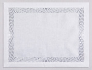 White linen placemat and napkin set embroidered with silver Paris motif border, 100% European linen, handcrafted by Plein Soleil.