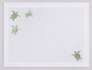 White linen placemat and napkin set embroidered with pistachio sea turtles, 100% European linen, handcrafted by Plein Soleil.