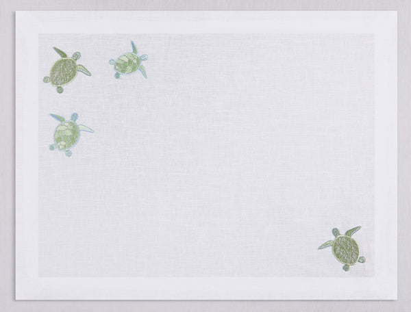 White linen placemat and napkin set embroidered with pistachio sea turtles, 100% European linen, handcrafted by Plein Soleil.