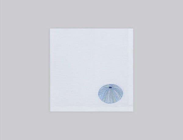 White linen cocktail napkin set embroidered with ice blue sea urchin, 100% European linen, handcrafted by Plein Soleil.