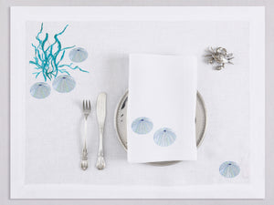 White linen placemat and napkin set embroidered with ice blue sea urchin and seaweed, 100% European linen, handcrafted by Plein Soleil.