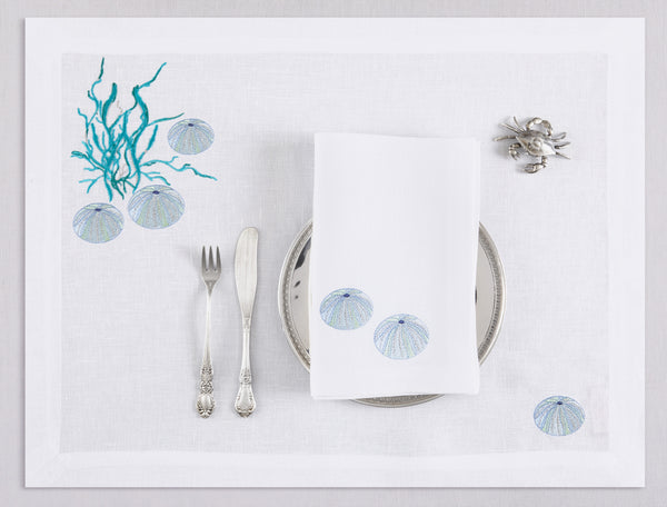 White linen placemat and napkin set embroidered with ice blue sea urchin and seaweed, 100% European linen, handcrafted by Plein Soleil.
